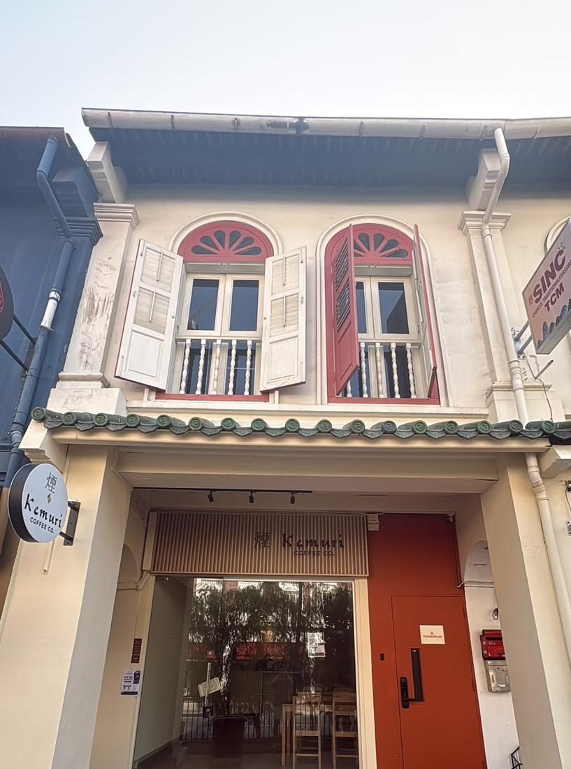 The Kemuri shophouse front on Tanjong Pagar Road, with red and white shutters, green eave tiles and the lit Kemuri sign